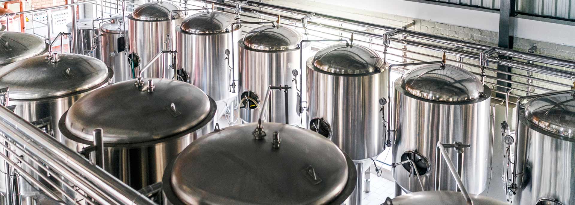 High angle view of metallic vats in a brewery.