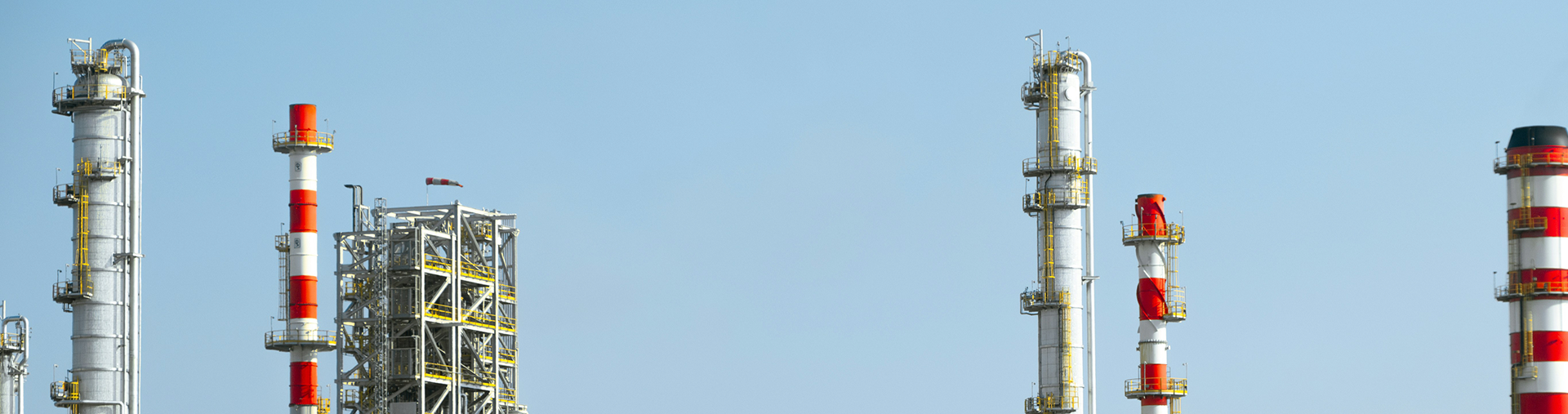 Manufacturing smokestacks against the sky