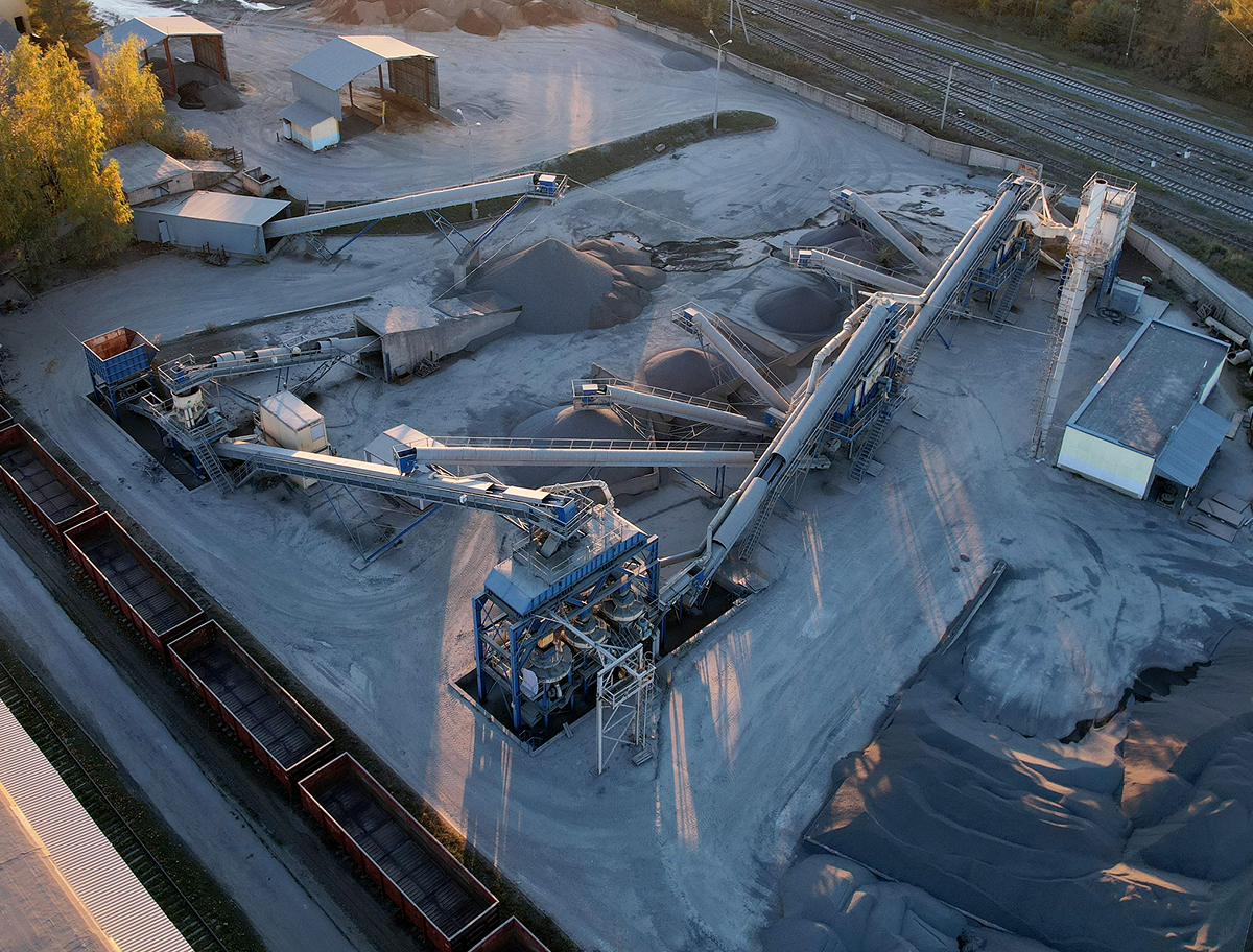 A concrete manufacturing plant with equipment and materials.